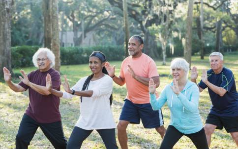 A group of people doing Tai Chi in the park